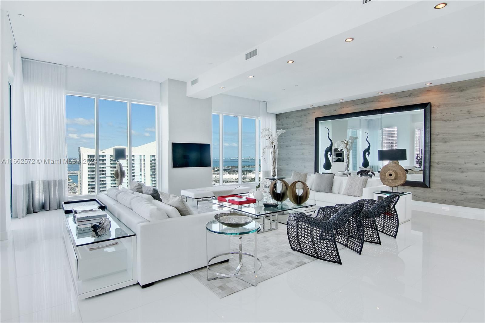 900 Brickell Key Boulevard, Unit PH3401 Miami, FL 33131 - Photo 9 of 58 a living room with furniture fireplace and a flat screen tv