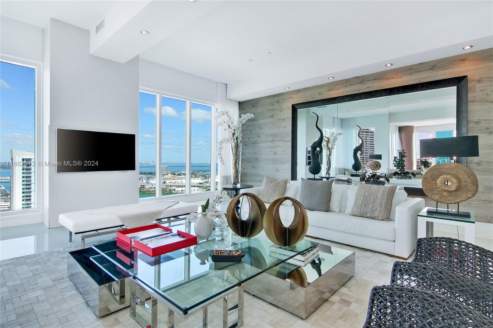900 Brickell Key Boulevard, Unit PH3401 Miami, FL 33131 - Photo 10 of 58 a living room with furniture and a flat screen tv