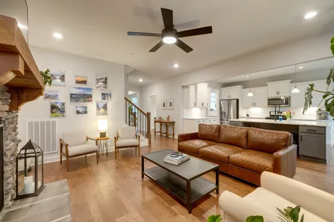 a kitchen with kitchen island a refrigerator a stove a sink and a wooden floors