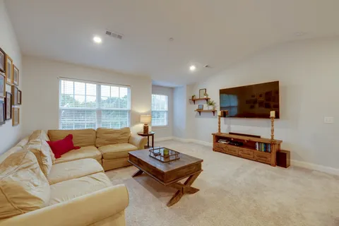 a living room with furniture and a lamp