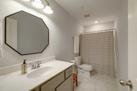 a bedroom with a bed and a night stand