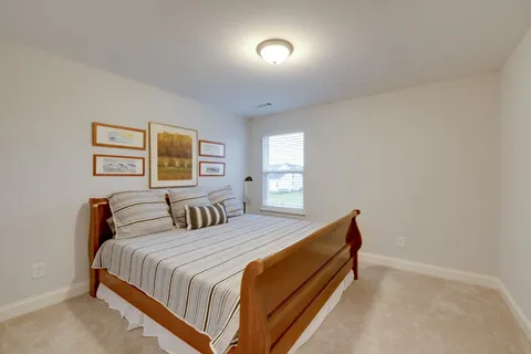 a bedroom with a bed and a painting on the wall