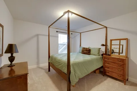 a bedroom with a bed and a mirror
