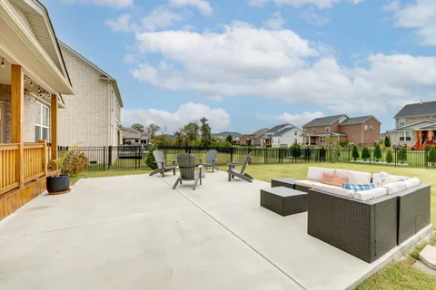 a view of house with swimming pool yard and outdoor seating