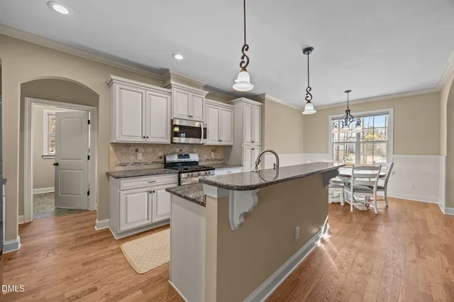 a kitchen with a stove and cabinets