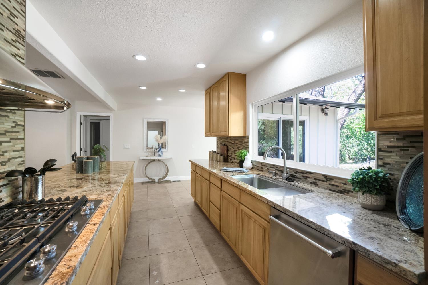 6299 Horseshoe Bar Road Loomis, CA 95650 - Photo 12 of 43 a kitchen with sink stove and cabinets