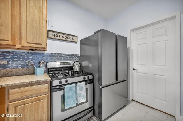 a kitchen with stainless steel appliances granite countertop a refrigerator stove and cabinets