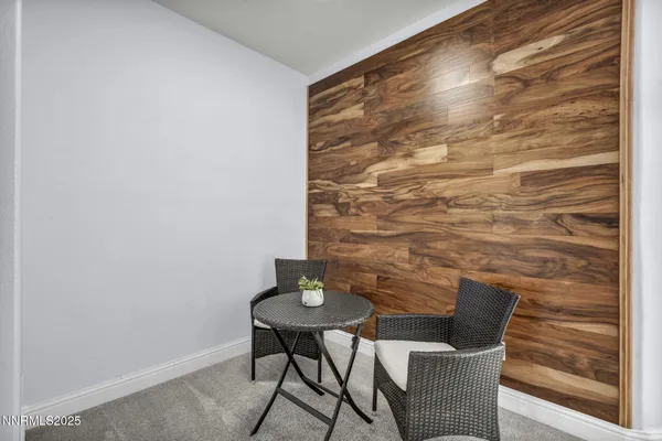 a living room with furniture a flat screen tv and a large window