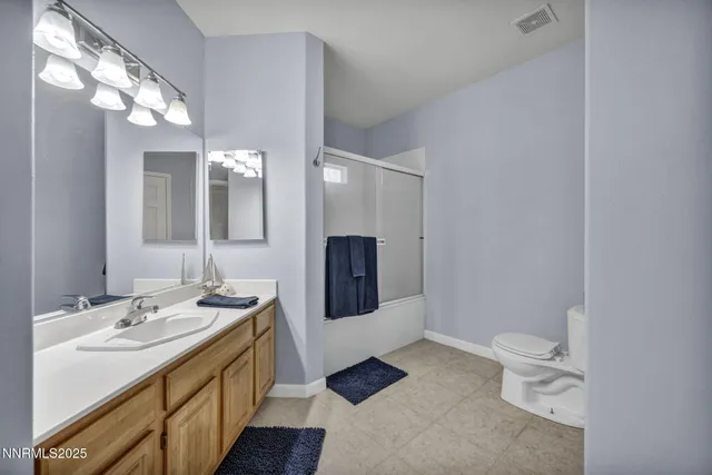 a bathroom with a sink double vanity granite and a mirror
