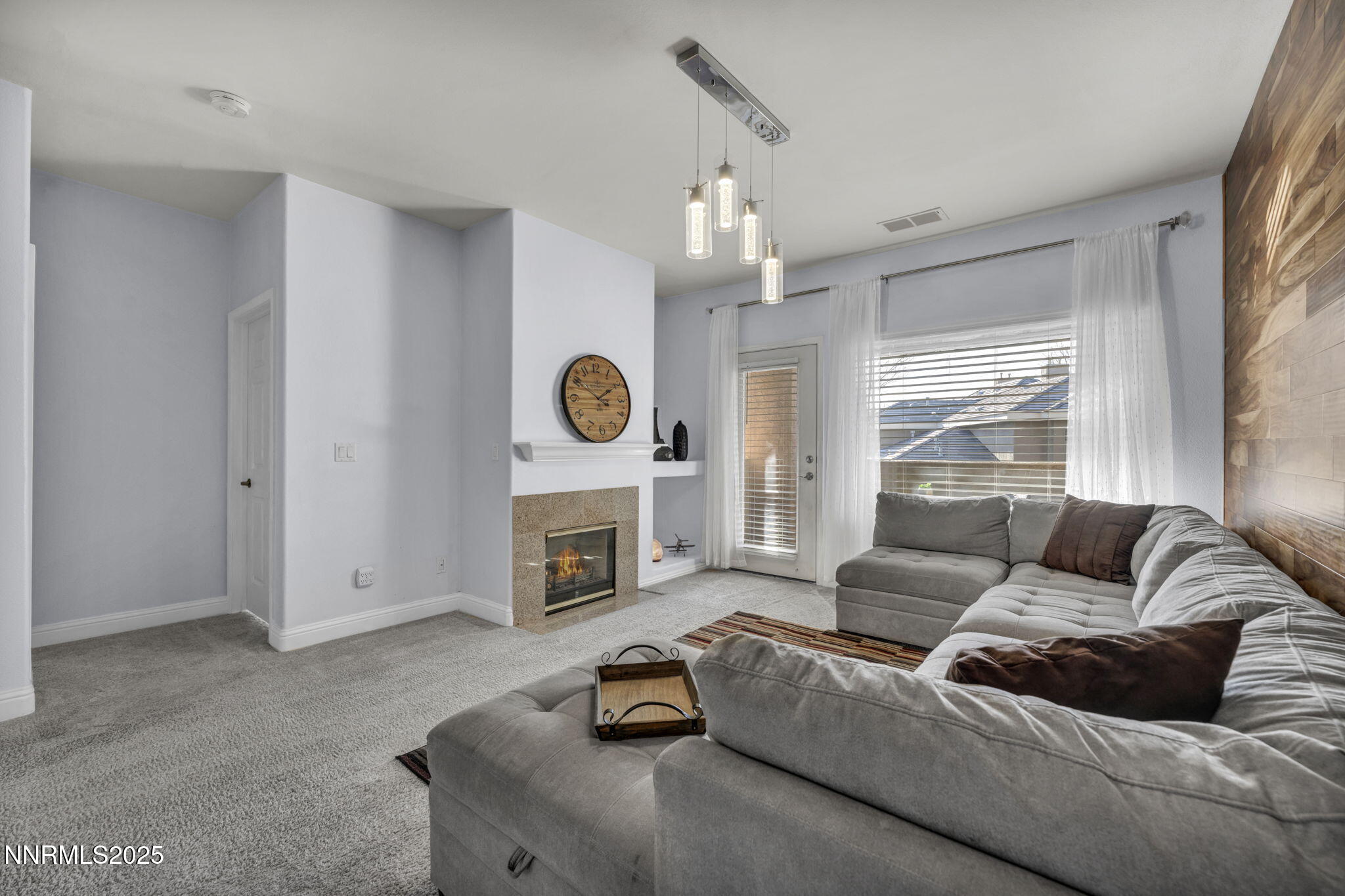 900 South Meadows Parkway, Unit 3223 Reno, NV 89521 - Photo 2 of 42 a living room with furniture and a fireplace