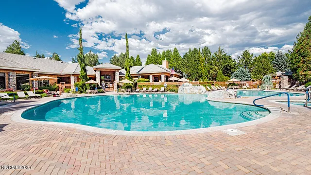 a living room with patio furniture and a floor to ceiling window