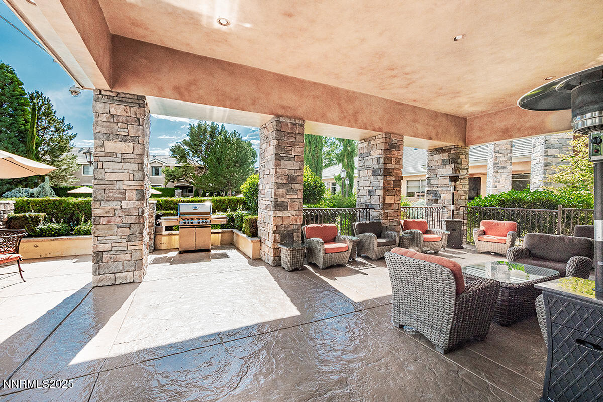 900 South Meadows Parkway, Unit 3223 Reno, NV 89521 - Photo 31 of 42 a living room with patio furniture and a floor to ceiling window