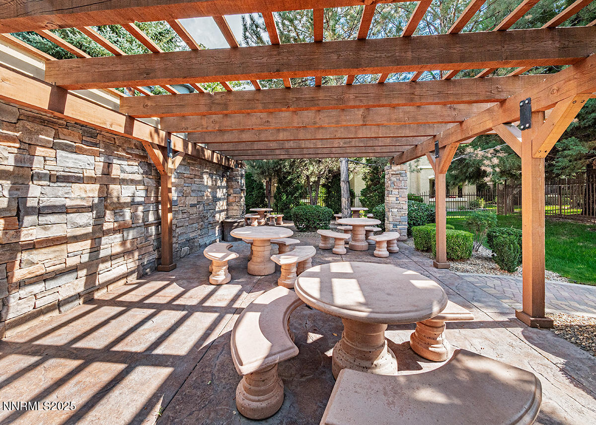 900 South Meadows Parkway, Unit 3223 Reno, NV 89521 - Photo 32 of 42 a view of a patio with table and chairs and potted plants