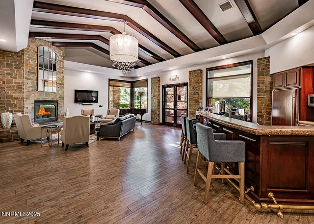 a living room with lots of furniture and a large window