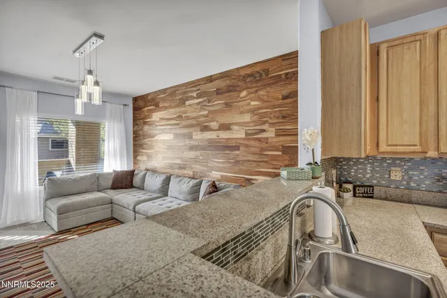 a kitchen with granite countertop a sink and a counter top space
