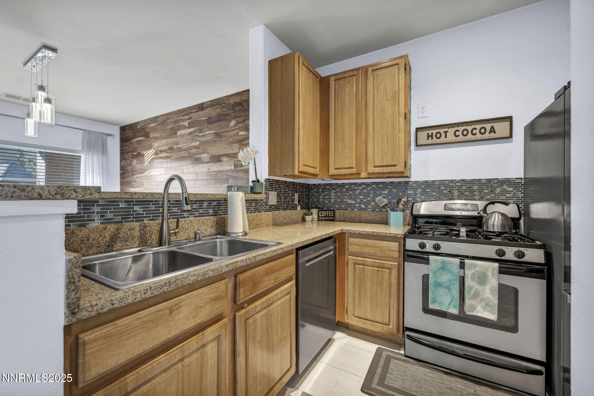 900 South Meadows Parkway, Unit 3223 Reno, NV 89521 - Photo 10 of 42 a kitchen with a sink stove and cabinets