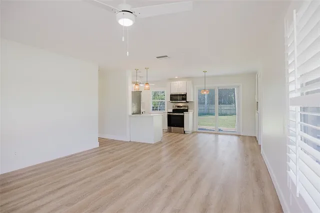 a kitchen with stainless steel appliances a stove microwave and a refrigerator
