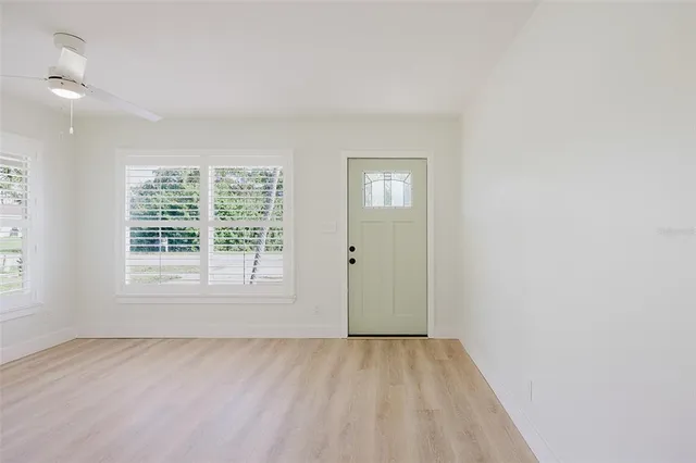 a kitchen with stainless steel appliances white cabinets and a refrigerator