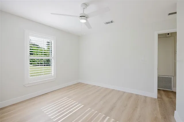 wooden floor in an empty room with a window