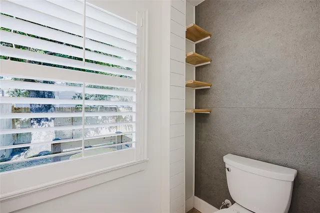 a view of swimming pool with a garden and outdoor seating