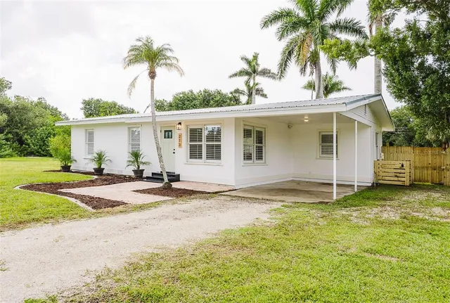 a view of a backyard with a tree
