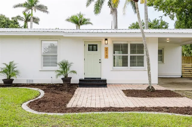 a front view of a house with a garden