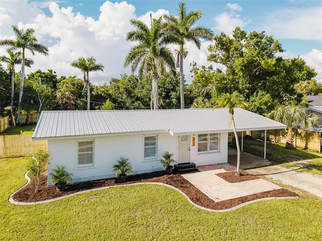 a backyard of a house with table and chairs