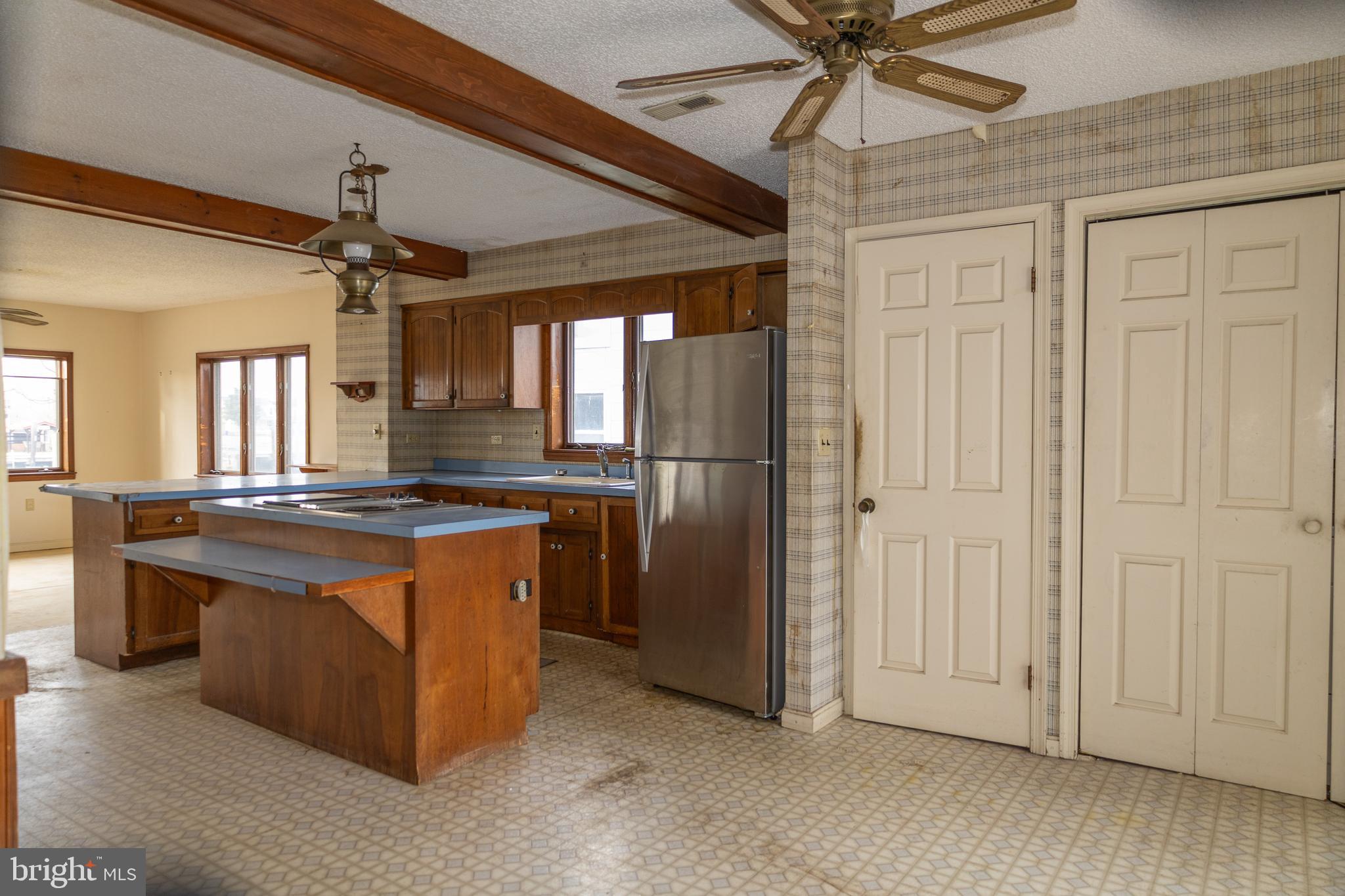 4404 South Bowers Road Milford, DE 19963 - Photo 17 of 53 a kitchen with stainless steel appliances granite countertop a stove and a refrigerator