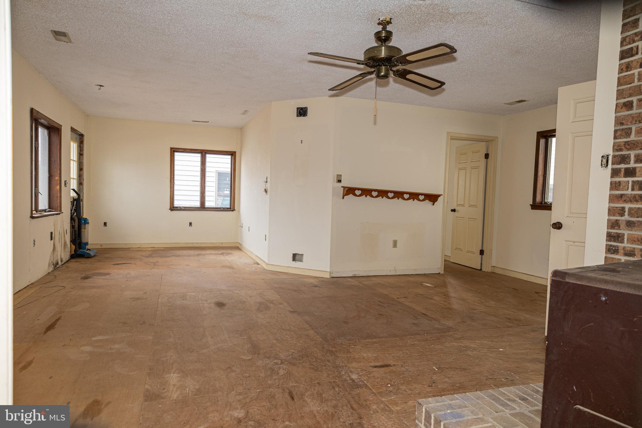 4404 South Bowers Road Milford, DE 19963 - Photo 25 of 53 a view of a livingroom with a window a ceiling fan and refrigerator