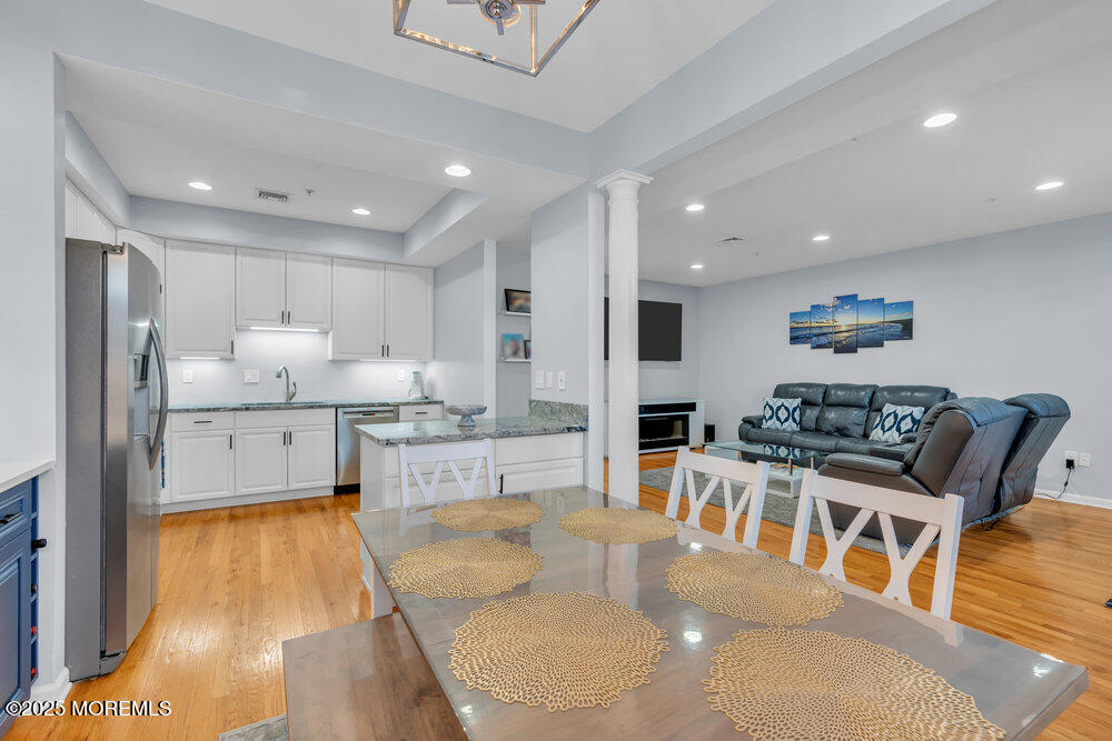 162 Main Street Manasquan, NJ 08736 - Photo 11 of 52 a living room with stainless steel appliances furniture and a wooden floor