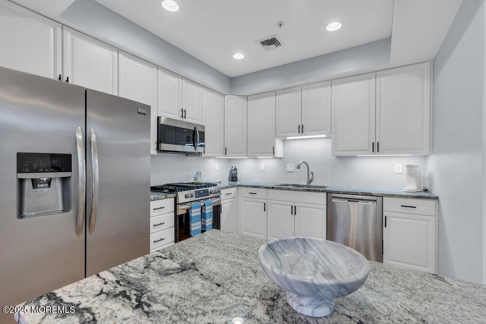 162 Main Street Manasquan, NJ 08736 - Photo 12 of 52 a kitchen with granite countertop a refrigerator stove top oven and sink