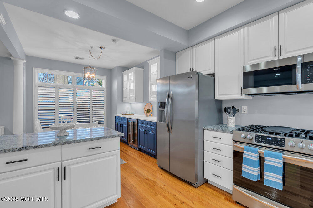 162 Main Street Manasquan, NJ 08736 - Photo 15 of 52 a kitchen with granite countertop a refrigerator and a stove top oven