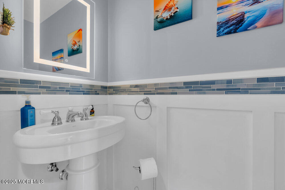 162 Main Street Manasquan, NJ 08736 - Photo 19 of 52 a bathroom with a sink and a mirror