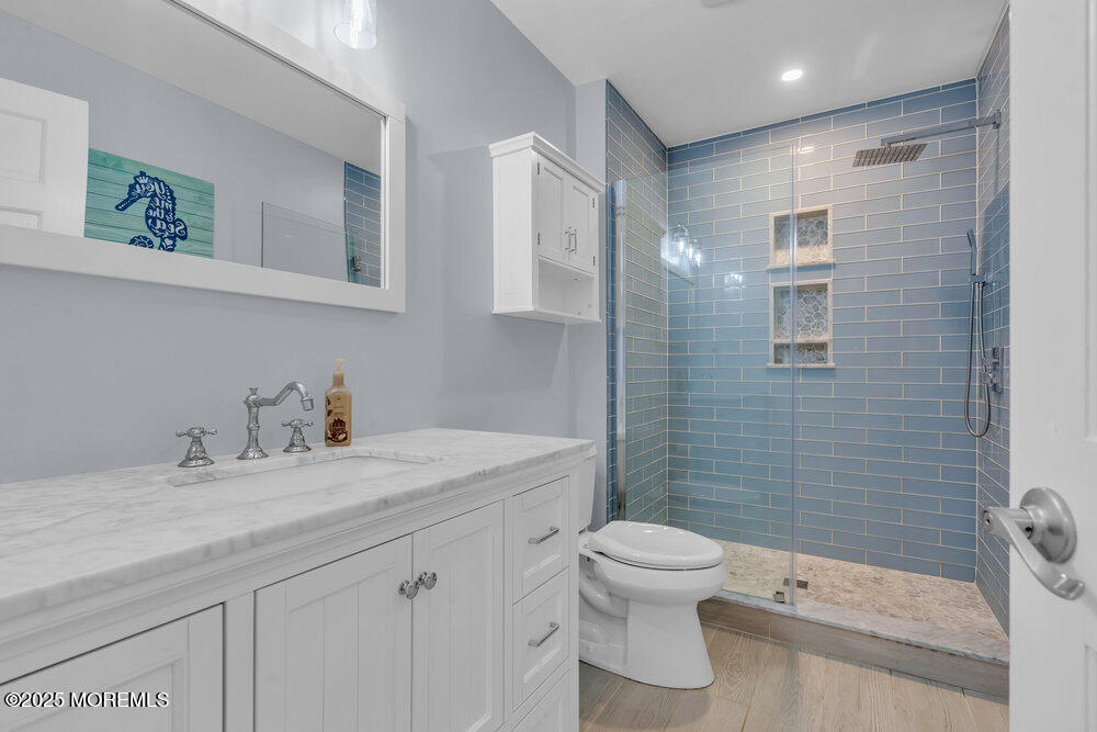 162 Main Street Manasquan, NJ 08736 - Photo 21 of 52 a bathroom with a granite countertop sink toilet and shower