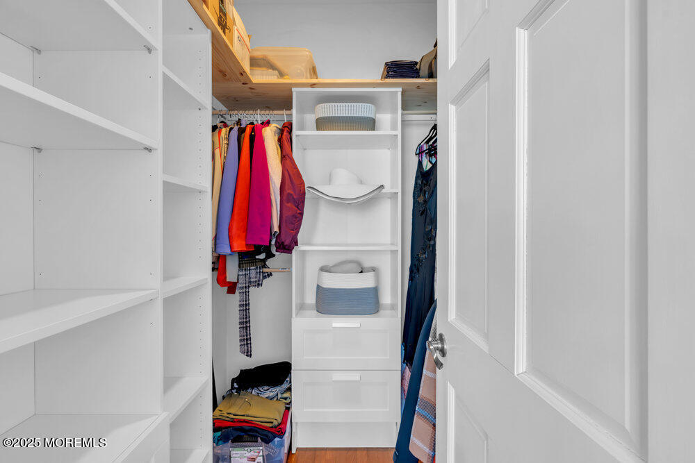 162 Main Street Manasquan, NJ 08736 - Photo 24 of 52 a view of walk in closet with clothes and shoes
