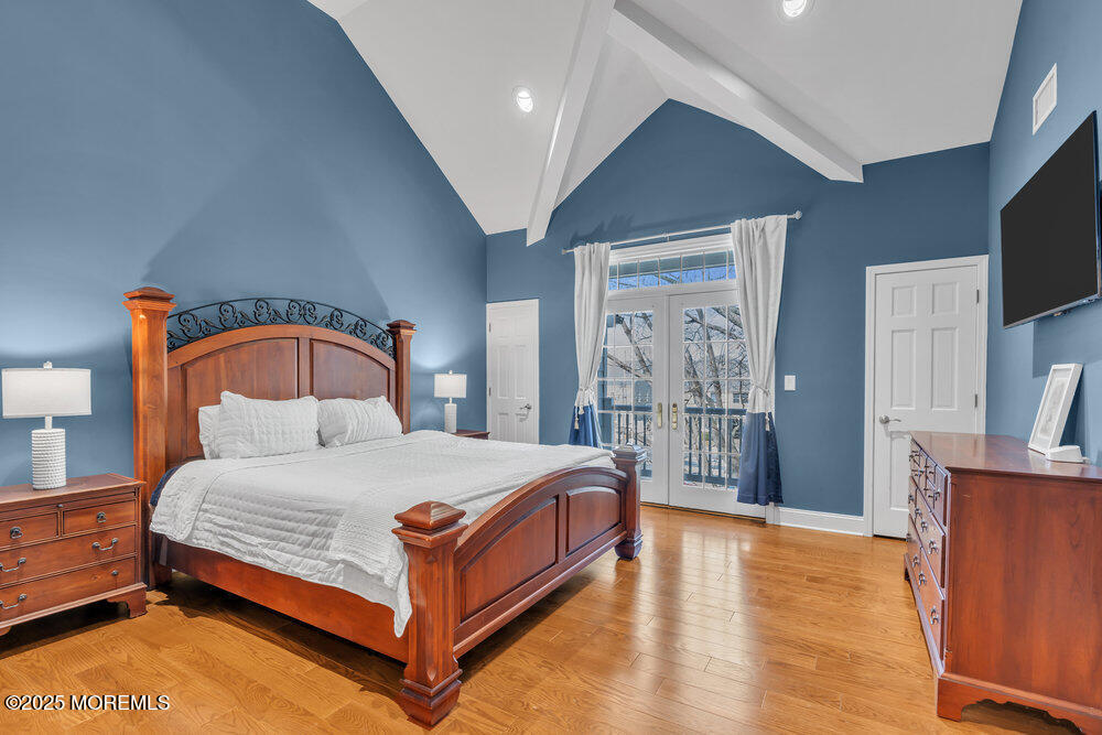 162 Main Street Manasquan, NJ 08736 - Photo 28 of 52 a bedroom with a bed a flat screen tv and dresser