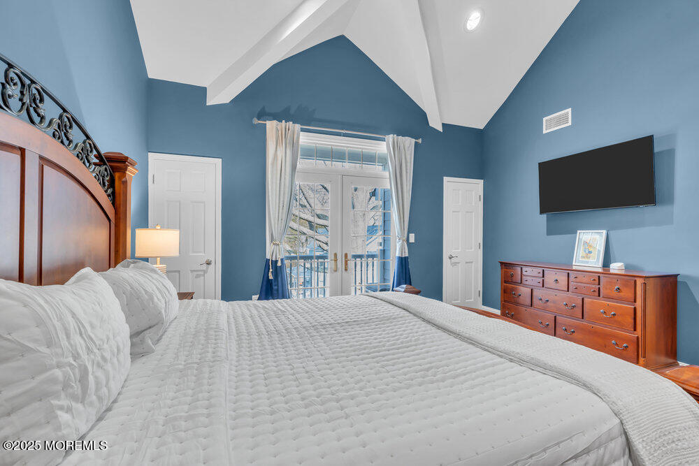 162 Main Street Manasquan, NJ 08736 - Photo 30 of 52 a bedroom with a bed and a flat screen tv