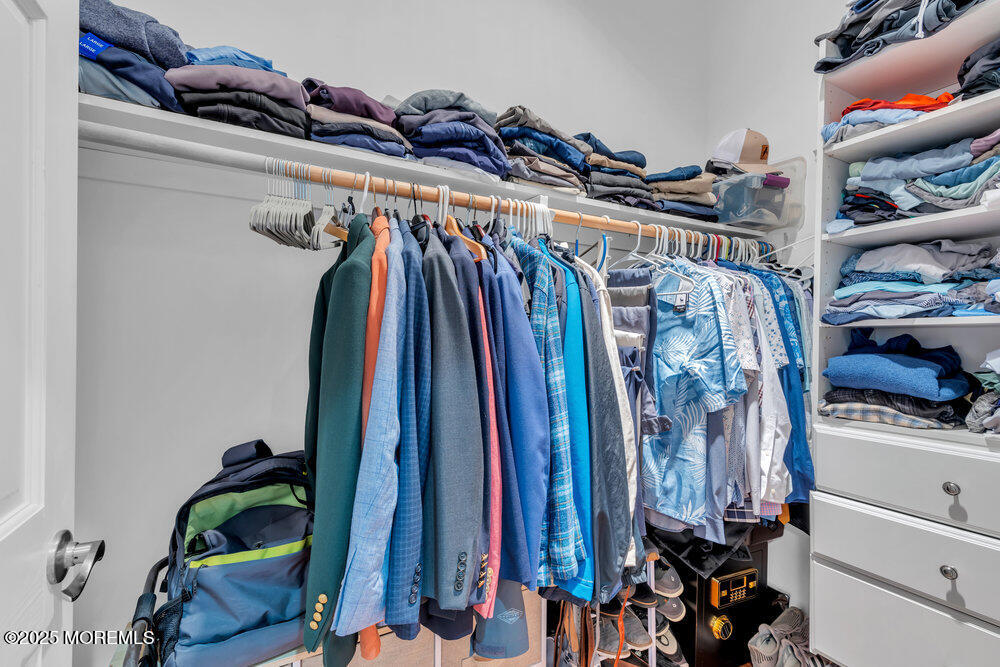 162 Main Street Manasquan, NJ 08736 - Photo 34 of 52 a view of walk in closet with clothes and shoes
