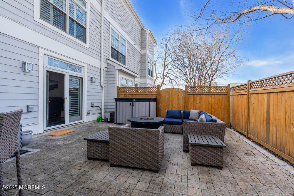 162 Main Street Manasquan, NJ 08736 - Photo 38 of 52 a view of a patio with couches and a fire pit