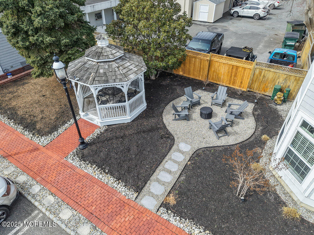 162 Main Street Manasquan, NJ 08736 - Photo 39 of 52 a backyard of a house with table and chairs