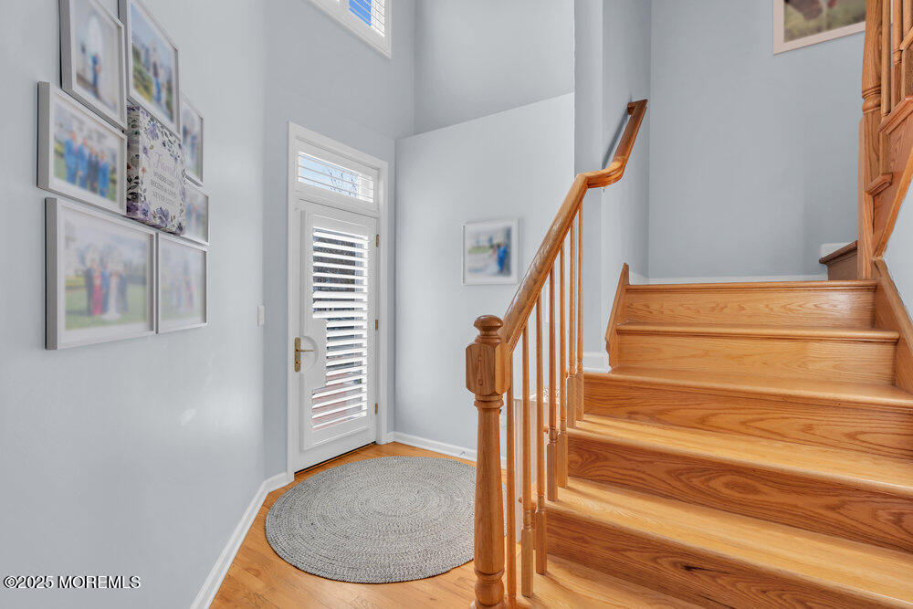 162 Main Street Manasquan, NJ 08736 - Photo 4 of 52 a view of staircase with white walls and a potted plant