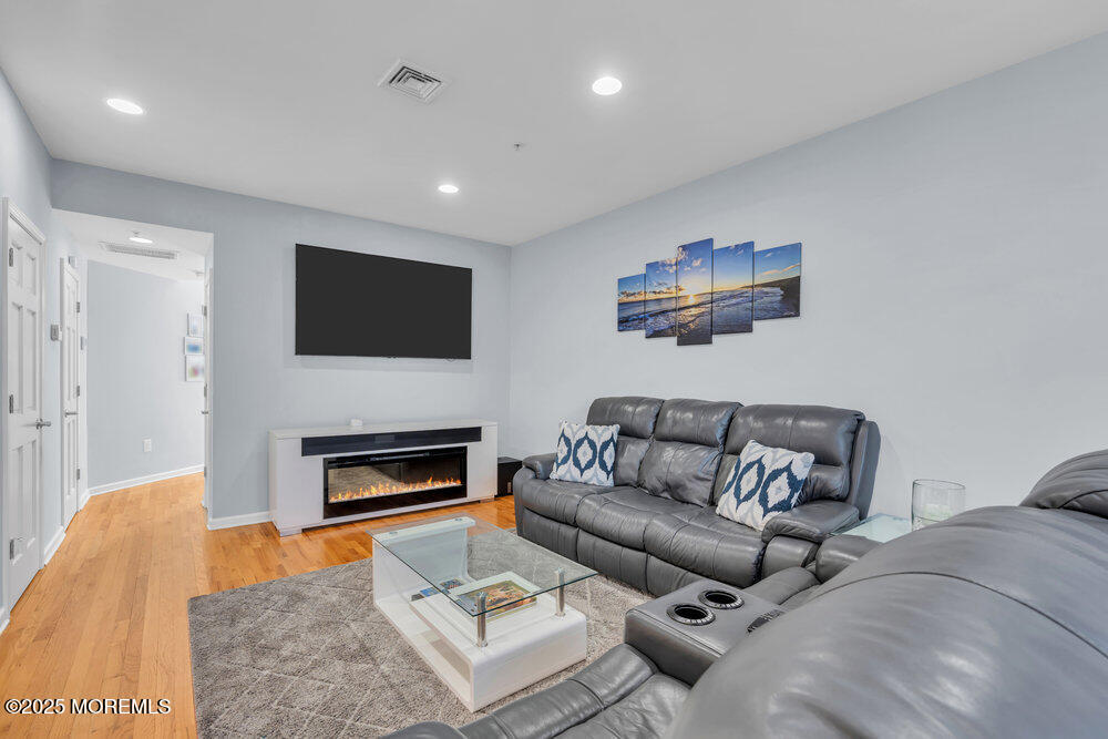 162 Main Street Manasquan, NJ 08736 - Photo 6 of 52 a living room with furniture a flat screen tv and a fireplace