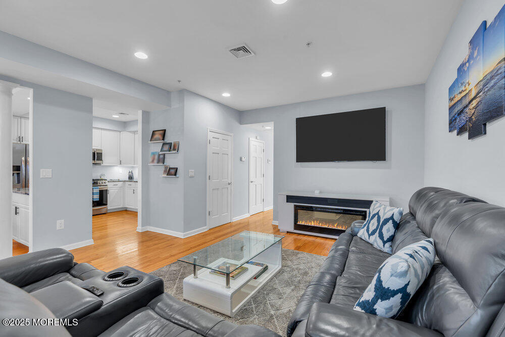 162 Main Street Manasquan, NJ 08736 - Photo 8 of 52 a living room with furniture flat screen tv and a fireplace