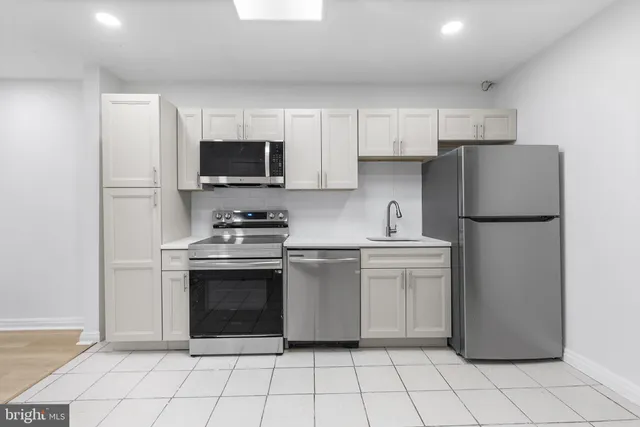 a kitchen with appliances cabinets and a sink