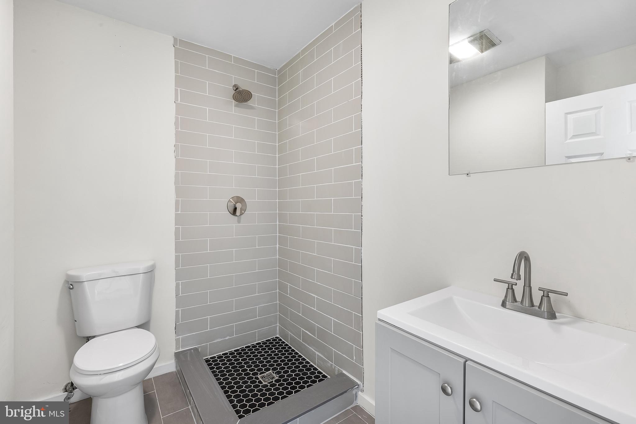 2120 Christian Street, Unit 2 Philadelphia, PA 19146 - Photo 4 of 10 a bathroom with a sink a toilet and shower