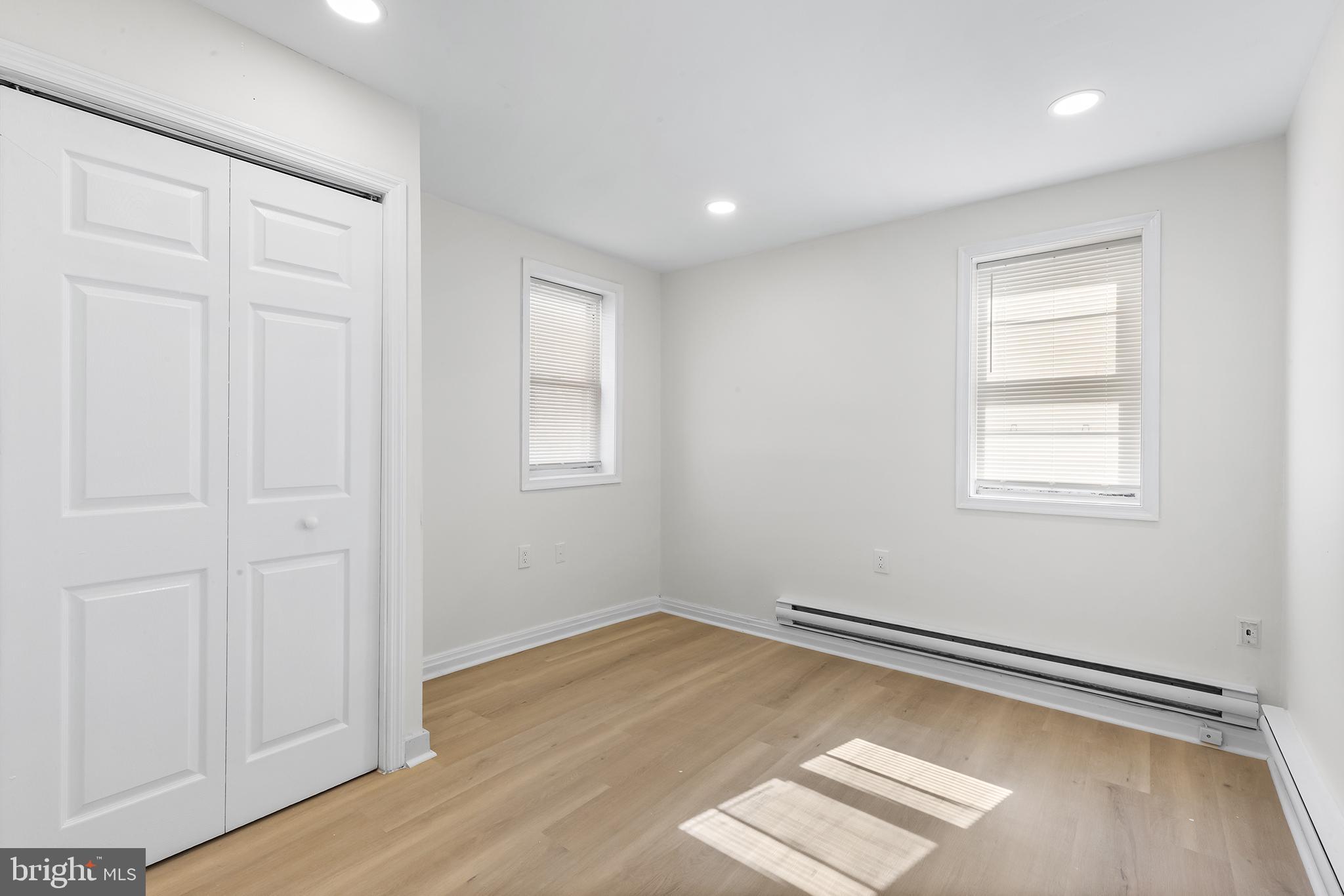 2120 Christian Street, Unit 2 Philadelphia, PA 19146 - Photo 5 of 10 an empty room with wooden floor and windows