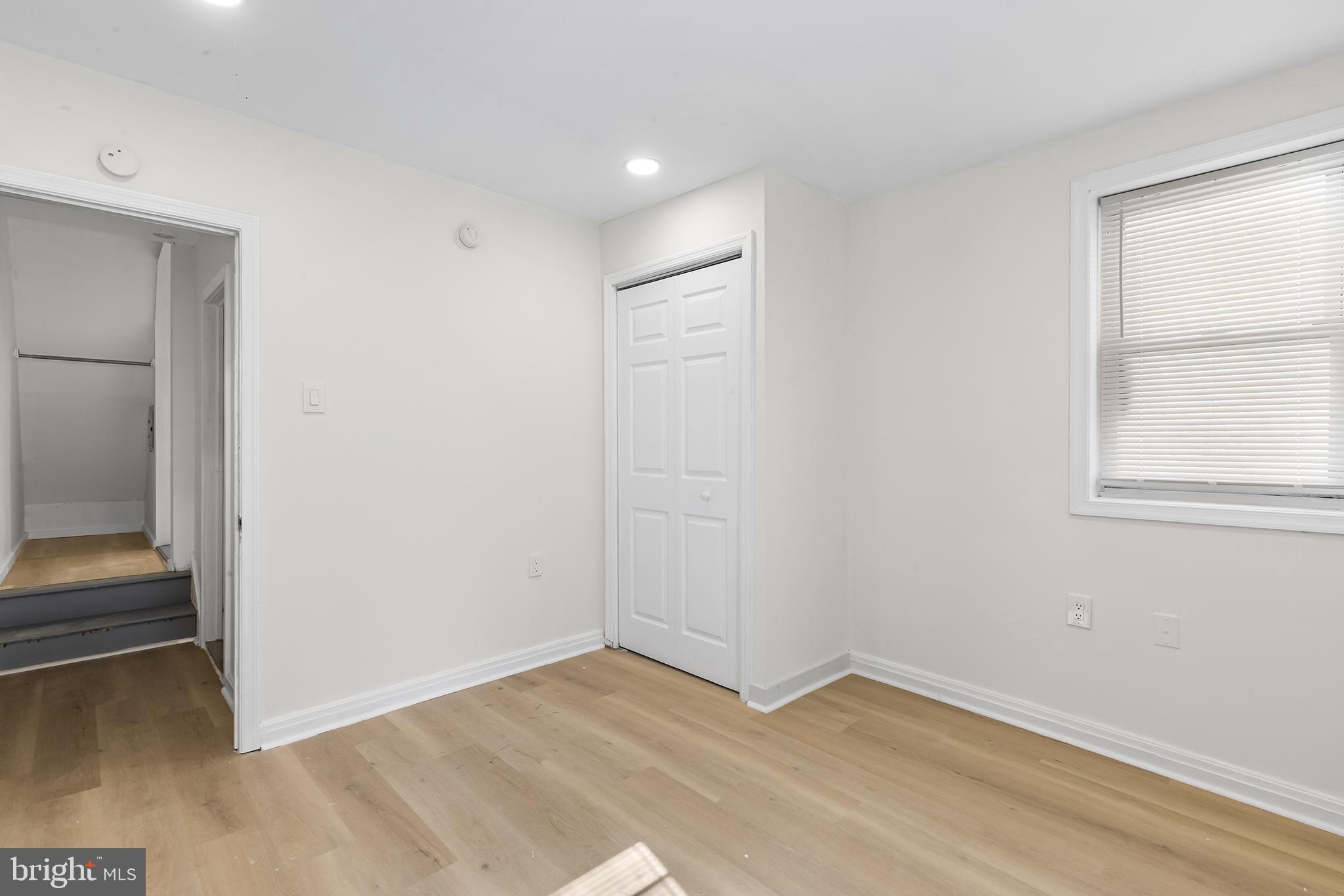2120 Christian Street, Unit 2 Philadelphia, PA 19146 - Photo 6 of 10 an empty room with wooden floor and windows
