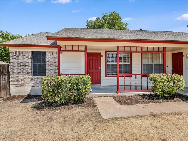 front view of a brick house with a large window
