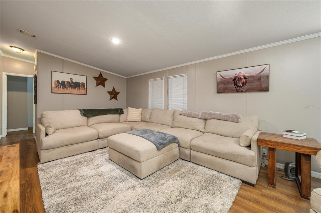 15079 Brahma Road Polk City, FL 33868 - Photo 18 of 40 a living room with furniture and a rug