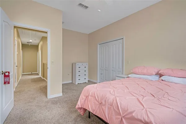 a bedroom with a bed and a mirror